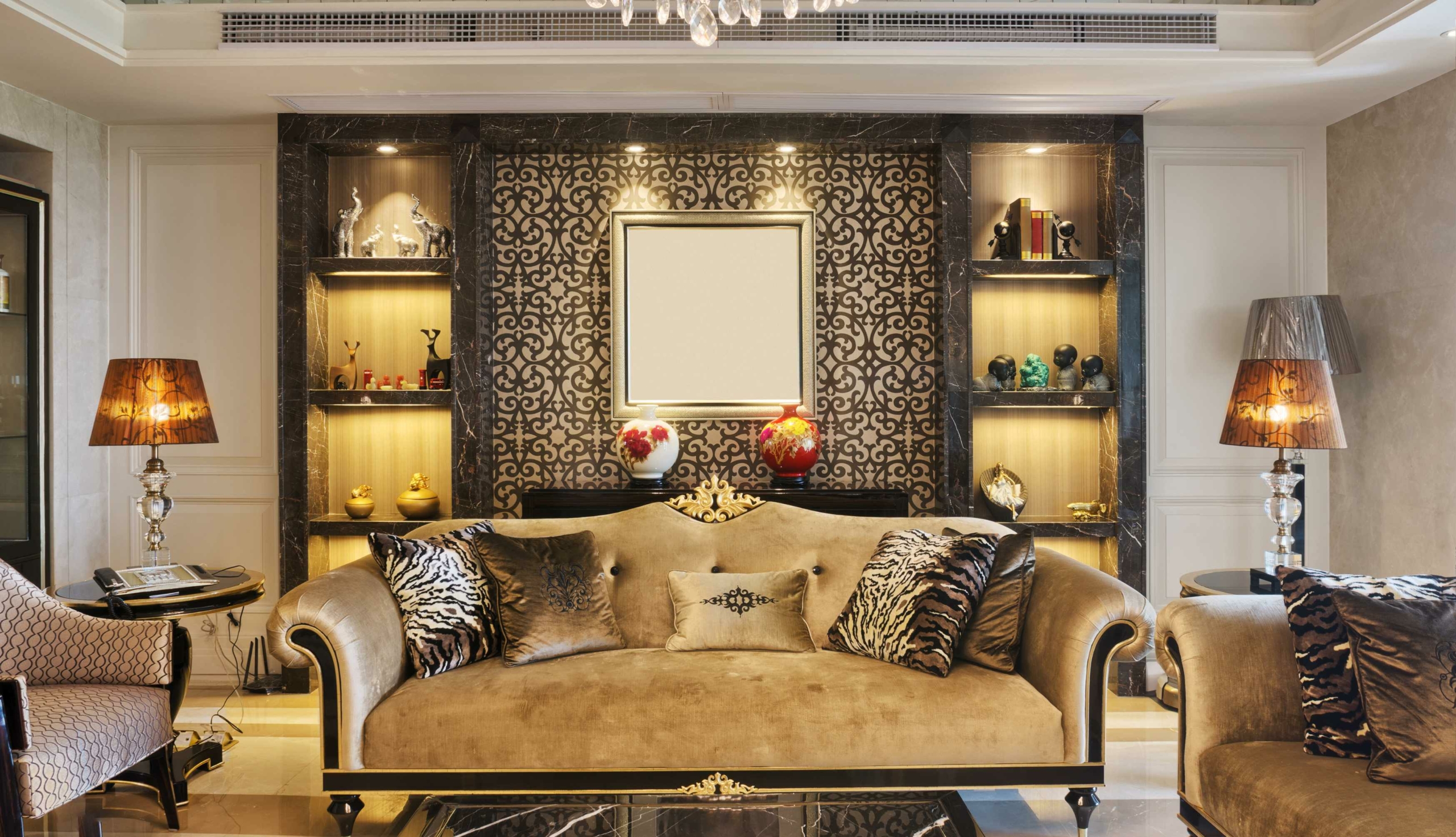 gold couch and chairs with ornate wall paper