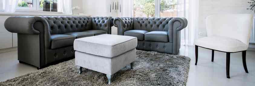 grey leather couch with grey rug