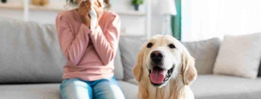 girl wiping her nose and a dog