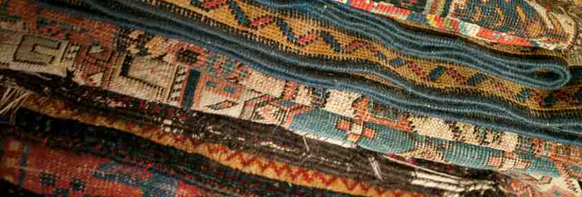 green and tan rugs in a pile