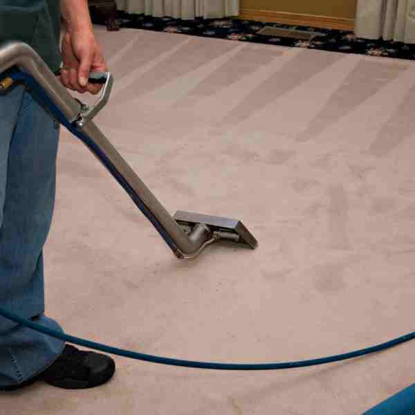 man cleaning a carpet