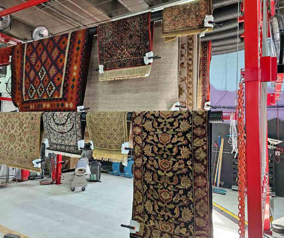 assortment of rugs drying on an drying rack