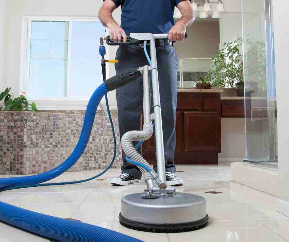 man cleaning bathroom tile floor professionally