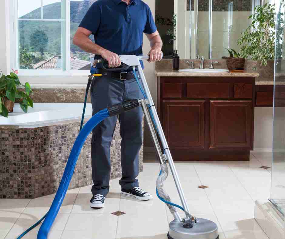 man cleaning tile floor professionally